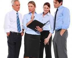 four professional people looking at a folder on white background