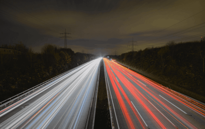 a highway at night with moving lights to suggest speed
