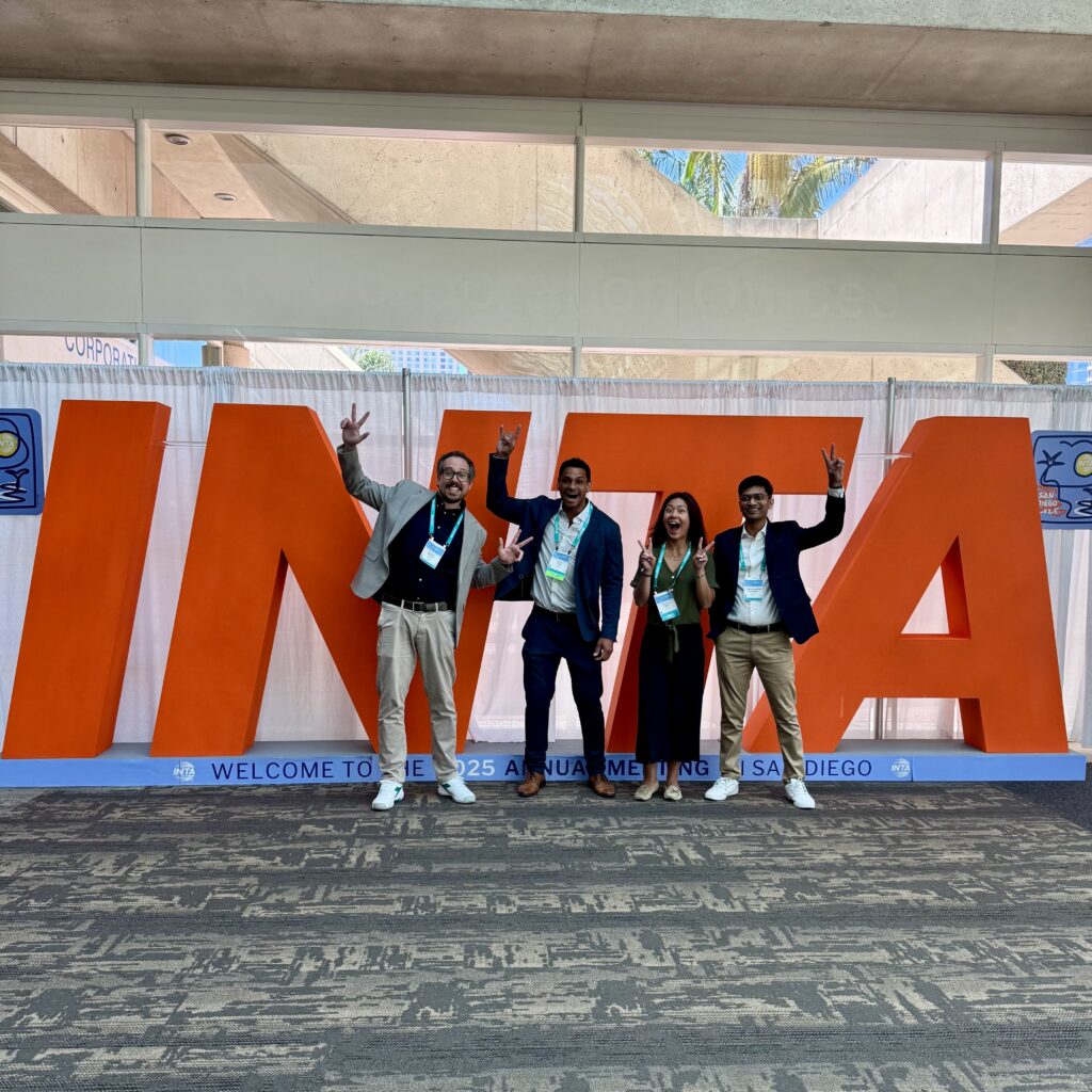 Four IP Pilot colleagues in front of the INTA letters at the 2025 Annual Meeting in San Diego