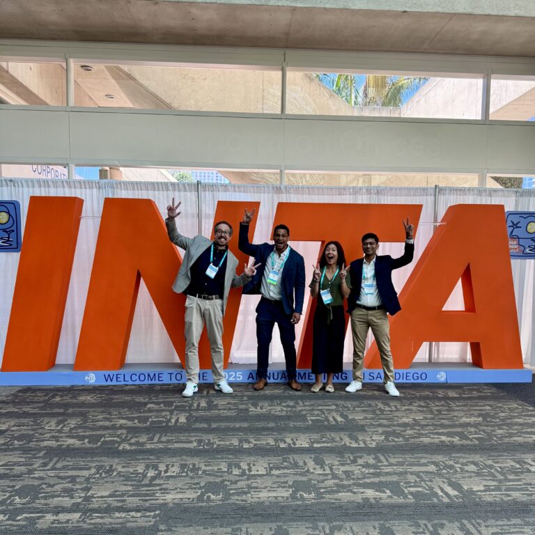 Four IP Pilot colleagues in front of the INTA letters at the 2025 Annual Meeting in San Diego