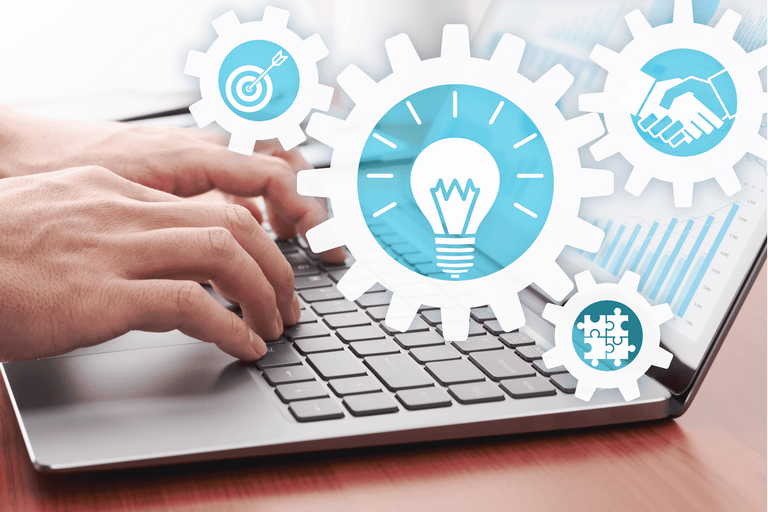 Hands typing on a laptop with overlaid gear icons for a target, a lightbulb, a handshake and jigsaw pieces